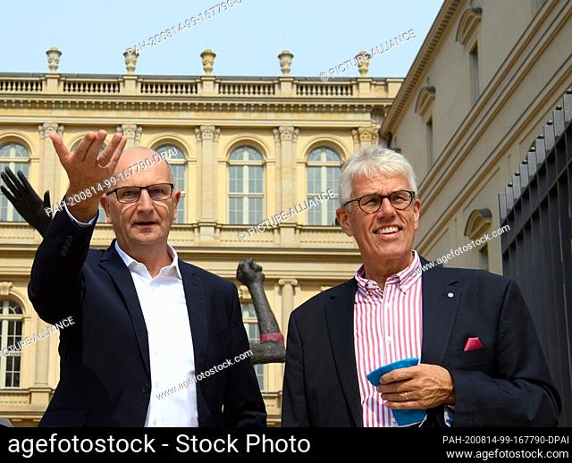 14 August 2020, Brandenburg, Potsdam: Dietmar Woidke (l, SPD), Minister President of Brandenburg, speaks during his press tour at the rear entrance to the...