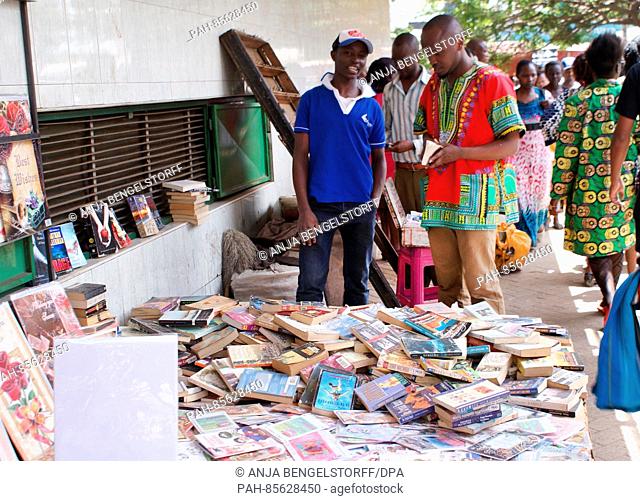 Francis Mbinda (L), 22-years-old, sells second hand books at the Tom Mboya Street in the Kenyan capital Nairobi, 23 October 2016