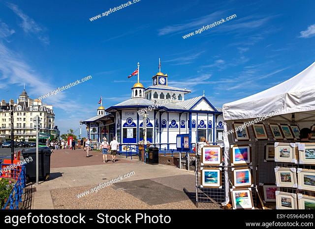EASTBOURNE, EAST SUSSEX, UK - JULY 29 : View along the promenade towards Eastbourne Pier in East Sussex on July 29 2021. Unidentified people