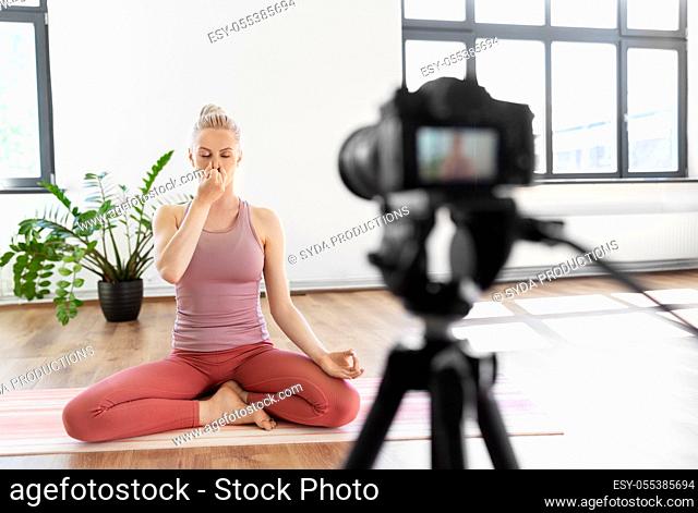 woman or blogger recording gym yoga class video