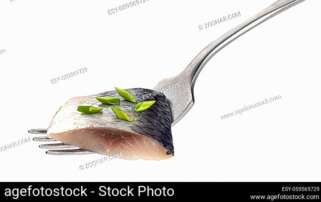 Pieces of salted herring on fork isolated on white background with clipping path, marinated mackerel fish fillet