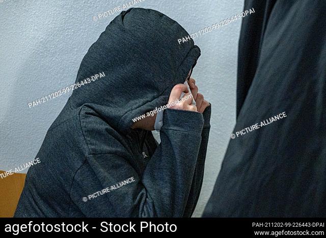 02 December 2021, Bavaria, Regensburg: The defendant sits in front of the courtroom of the district court. The 33-year-old woman is accused of murdering her...