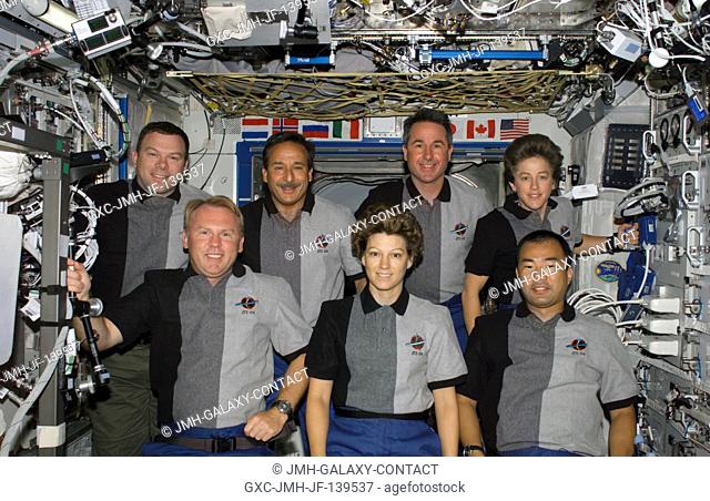 The STS-114 crewmembers pose for their traditional in-flight crew portrait in the Destiny laboratory of the international space station