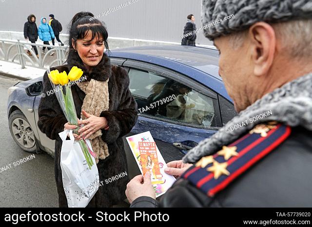 RUSSIA, YEKATERINBURG - MARCH 7, 2023: Pol Col Pavel Bondar congratulates a woman driver on 8 Marta Street ahead of International Women's Day