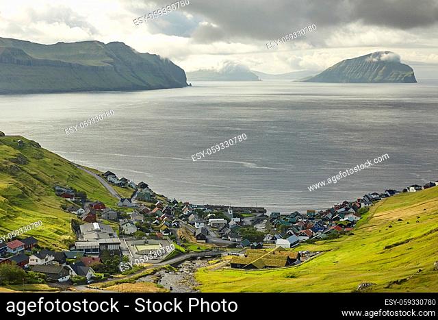 Village in wild and beautiful coastal landscape of Faroe Islands, Denmark