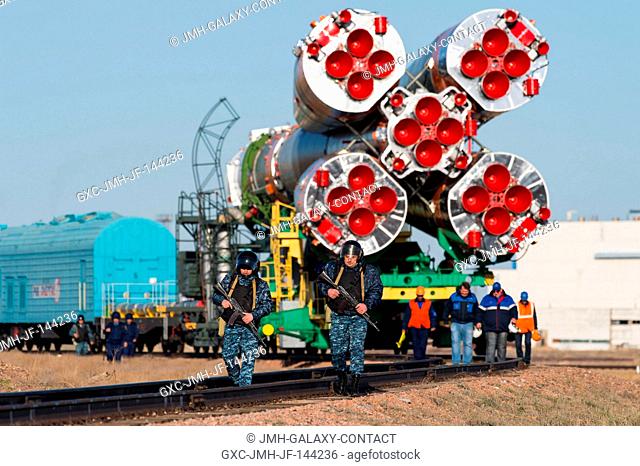 Russian security is seen as the Soyuz MS-04 spacecraft is rolled out to the launch pad by train on Monday, April 17, 2017 at the Baikonur Cosmodrome in...