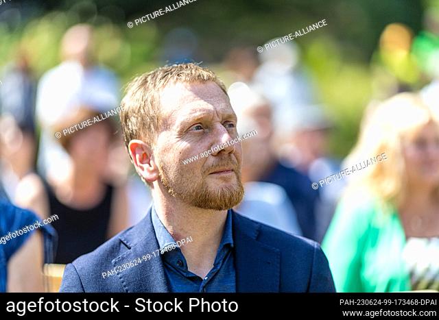 24 June 2023, Saxony, Bad Muskau: Michael Kretschmer (CDU), Prime Minister of Saxony, sits at the ceremony marking the 200th anniversary of the Hermannsbad in...