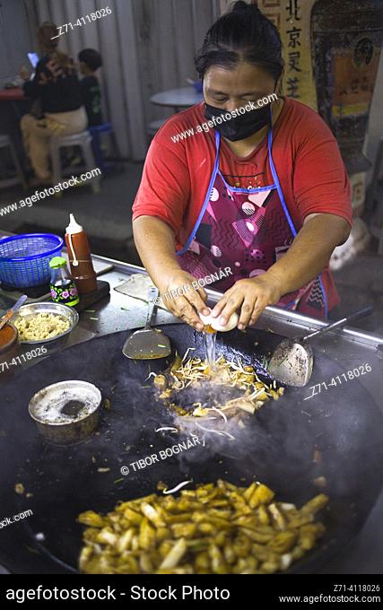 Malaysia, Penang, Georgetown, street food, cook. Penang is known as Malaysia's street food capital, with the city of Georgetown being the culinary hub of the...
