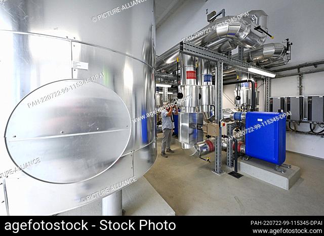 21 July 2022, Brandenburg, Potsdam: ""District heating return"" is written on the pipes in the solar thermal power plant of Potsdam's municipal utility