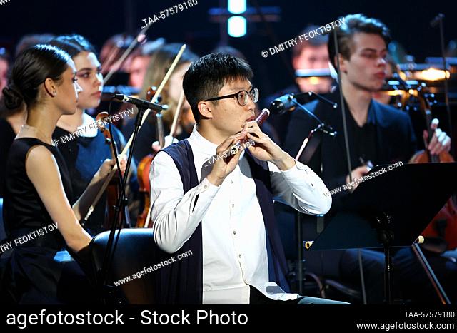 RUSSIA, SOCHI - FEBRUARY 26, 2023: Dizi player Nicky Kwok Chun-hei (C front) performs with the All-Russian Youth Symphony Orchestra are seen during a gala...