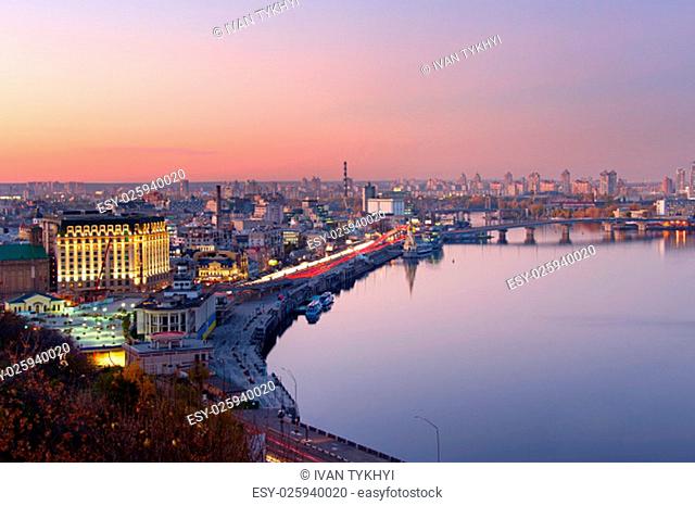 Aerial view of Kyiv with reflection in Dnipro river at dusk. Ukraine