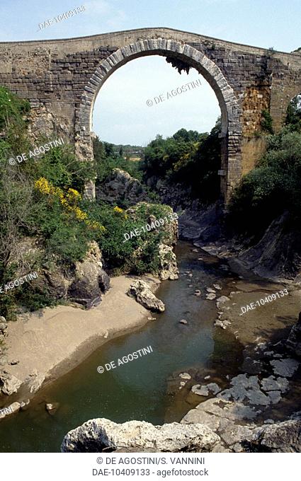 The Bridge of the Badia on the River Fiora, of Etruscan origin and remodelled in Roman and medieval times, Vulci, Lazio, Italy