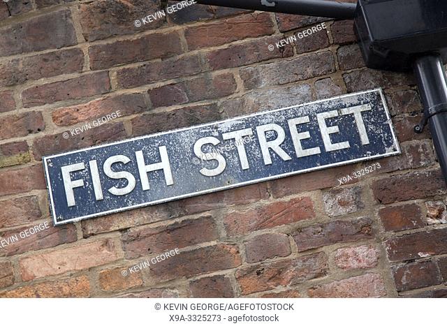 Fish Street Sign on Brick Wall Facade