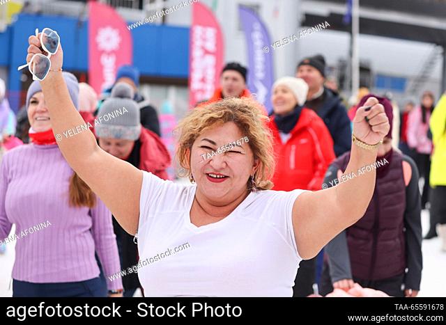 RUSSIA, KABARDINO-BALKAR REPUBLIC - DECEMBER 9, 2023: A woman attends a concert marking the start of the winter season at the Elbrus ski resort