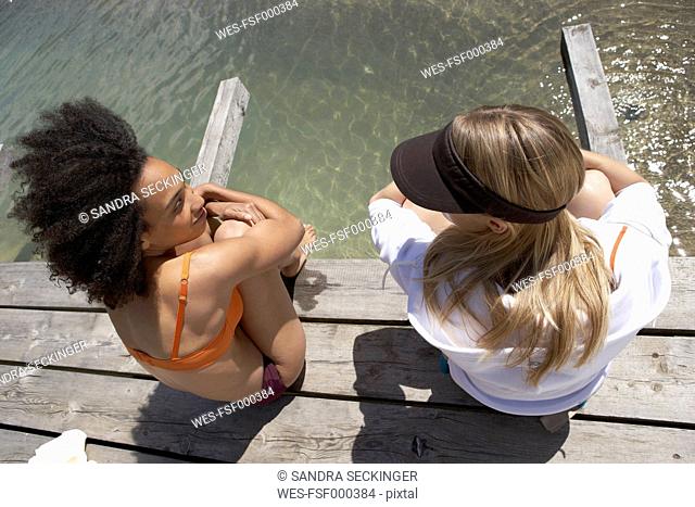Switzerland, two young women relaxing on sun deck