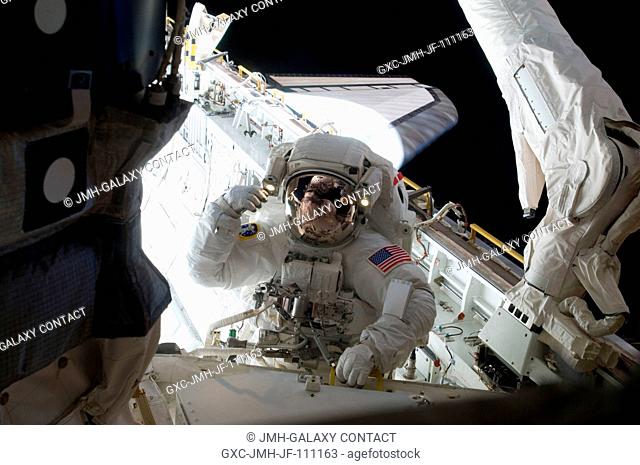 Astronaut Randy Bresnik, STS-129 mission specialist, participates in the mission's third and final session of extravehicular activity (EVA) as construction and...