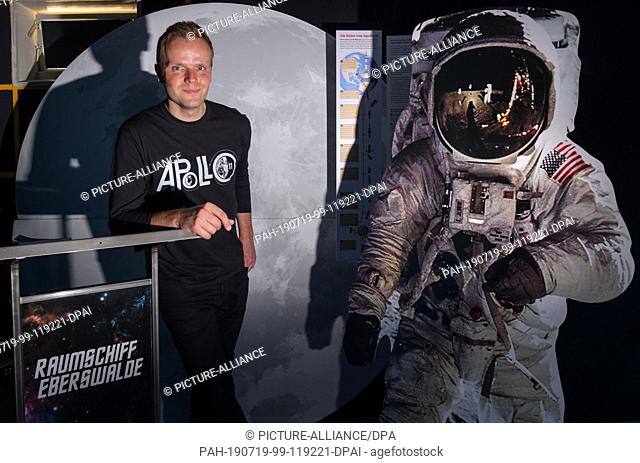 17 July 2019, Brandenburg, Eberswalde: Benjamin Stöwe, owner of the Star Trek Museum ""Spaceship Eberswalde"", stands next to a display with a photo of the...