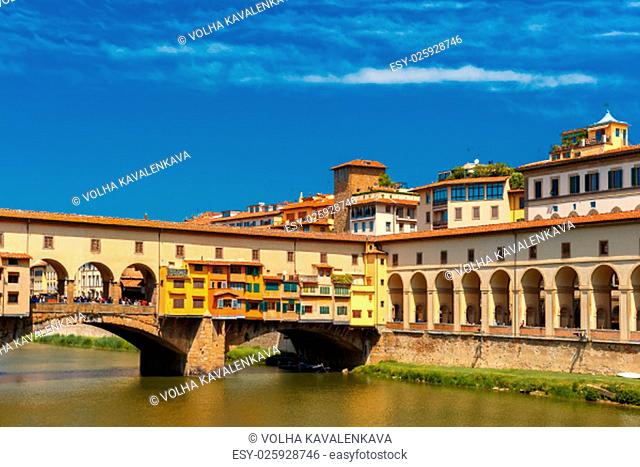 Bridge Ponte Vecchio across River Arno in the sunny summer day, Florence, Tuscany, Italy