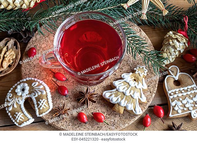 A cup of rose hip tea with Christmas gingerbread cookies