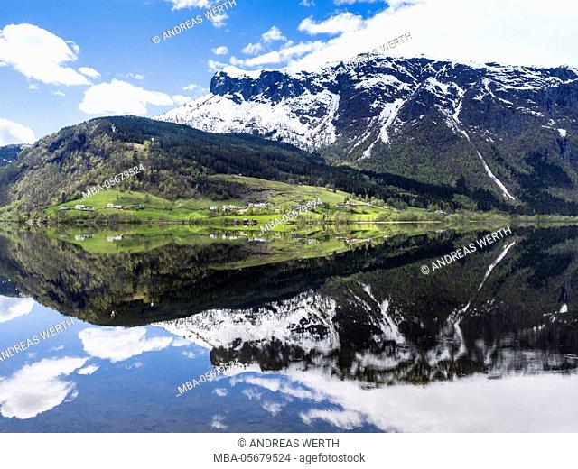 Reflection of the mountains meeting the sea at Granvinsvatnet, in Hardanger, Norway