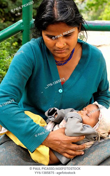 nepalis lady holding her baby and begging, the nepalis , life in kathmandu , kathmandu street life , nepal