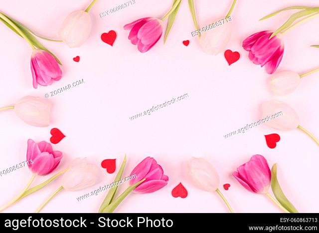 Frame made of colourful tulips and red hearts Valentines day background