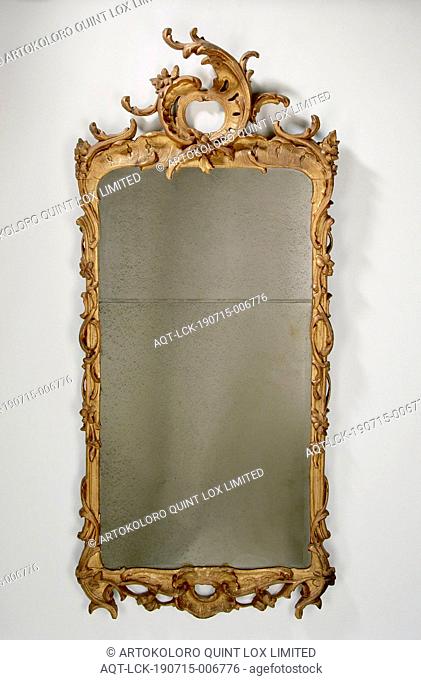 Mirror with gilt frame, Louis XV style mirror with gilt carved wooden frame. The frame is decorated with stylized leaf and flower ornament and is crowned by a...