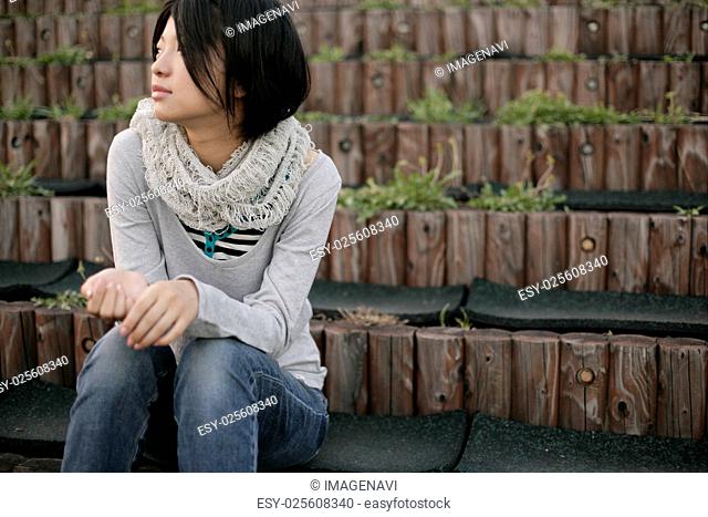 Young woman sitting outside