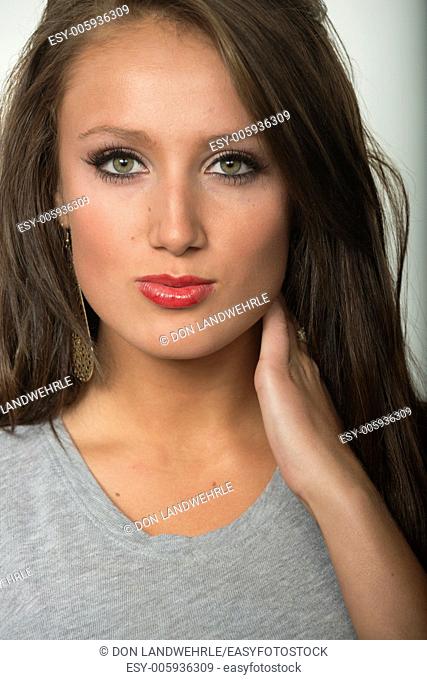Attractive young girl in front of a white seamless