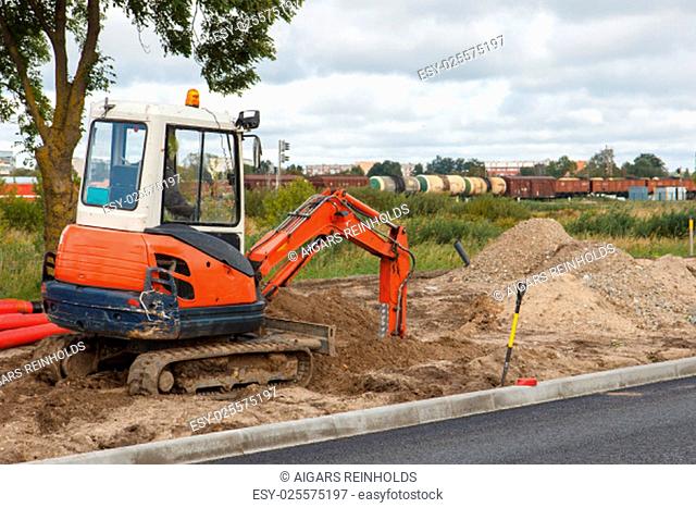 An excavator in a road construction site