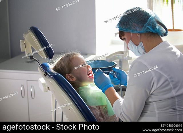 Little child in stomatology chair - children dentistry, close up