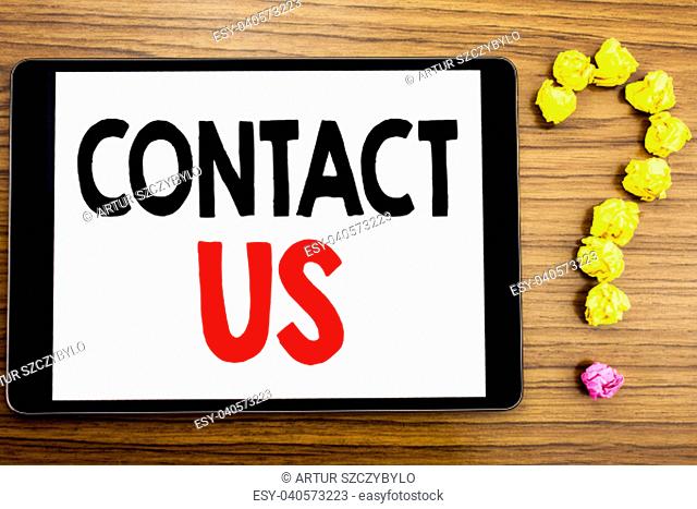 Writing text showing Contact Us. Business concept for Customer Support written on tablet computer on wooden background with question mark made of folded paper