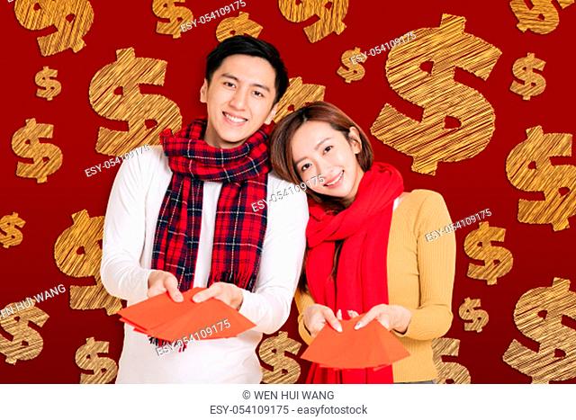 asian young couple celebrating for chinese new year. chinese text happy new year 2020