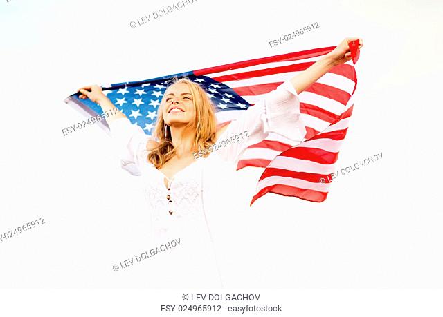 country, patriotism, independence day and people concept - happy smiling young woman in white dress with national american flag outdoors