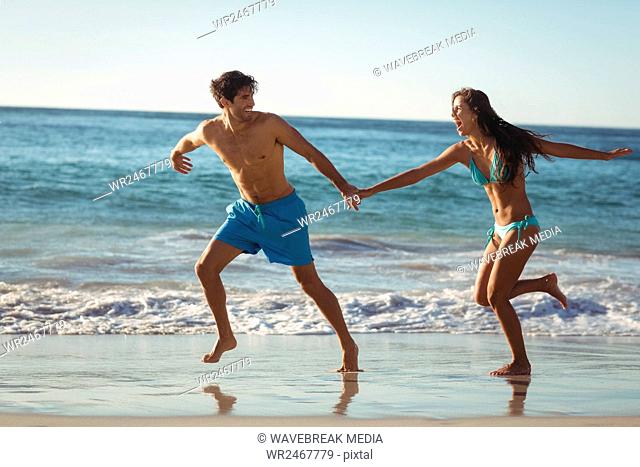 Couple running on beach