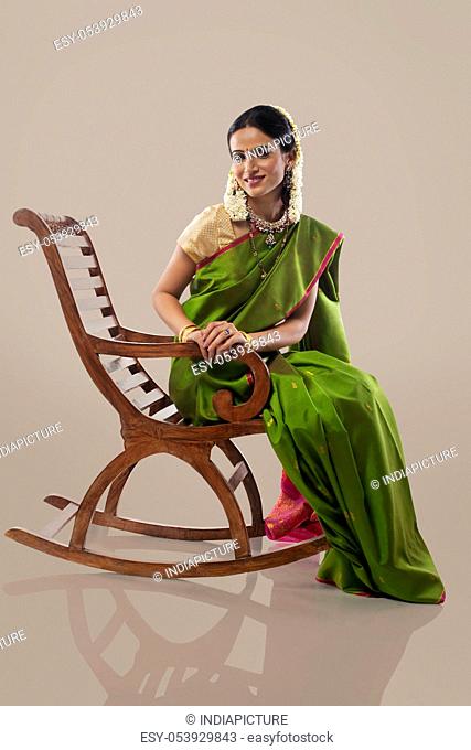 South Indian woman sitting on an arm chair