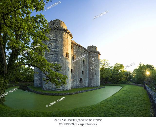 Nunney Castle and moat in the village of Nunney, Somerset, England
