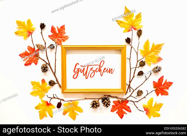Golden Frame With German Text Gutschein Means Voucher. Beautiful, Colorful Autumn Leaf Decoration With Maple Leaf And Fir Cone. White Background
