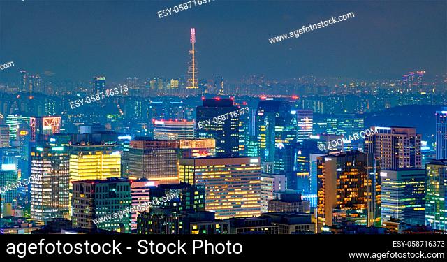 Seoul downtown cityscape illuminated with lights in the evening view from Inwang mountain. Seoul, South Korea