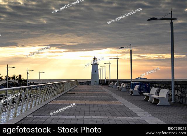 Sunrise with lighthouse at the harbour pier in Porto Maurizio, Imperia, Liguria, Italy, Europe