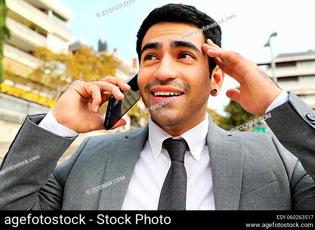 Outdoor portrait of business man, speaking on the phone. High quality photo