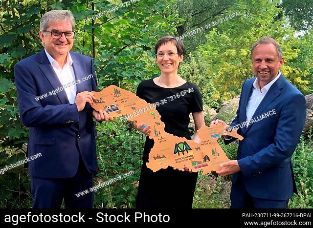 11 July 2023, Bavaria, Neuschönau: mts handover in the Bavarian Forest National Park: Ursula Schuster (M) succeeds director Franz Leibl (l) as of 01