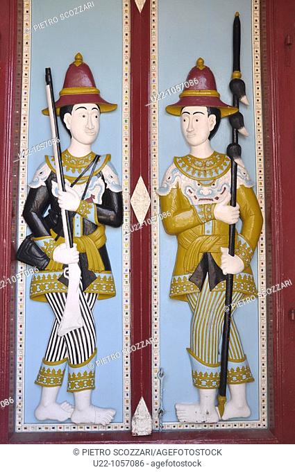 Bangkok (Thailand): ancient guards on a door's relief at the Royal Palace