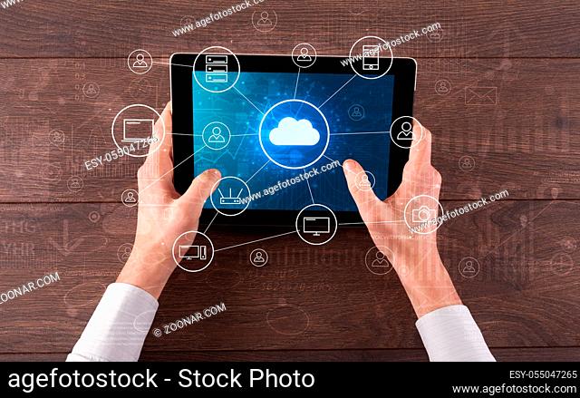 Hand touching tablet with cloud computing and online storage concept