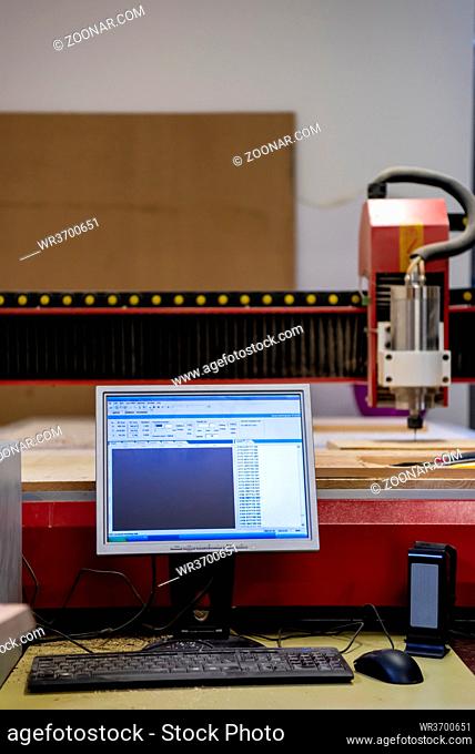 wood milling on modern automatic woodworking machine with CNC. furniture production