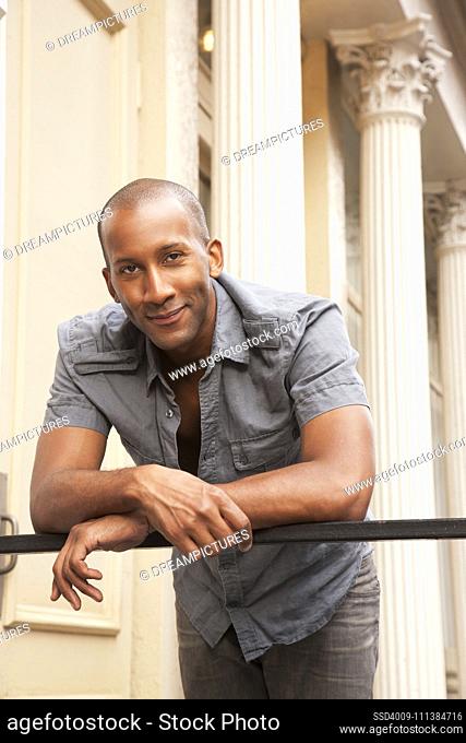 African American man leaning over banister