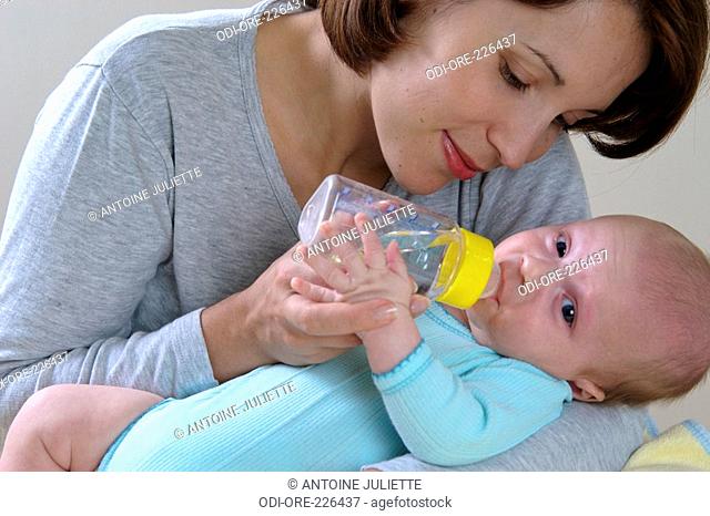 Woman baby feed bottle