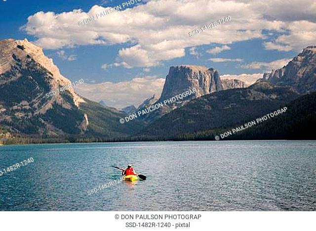 Front view of a person kayaking in a lake, Squaretop Mountain, Green River Lake, Bridger-Teton National Forest, Wyoming, USA