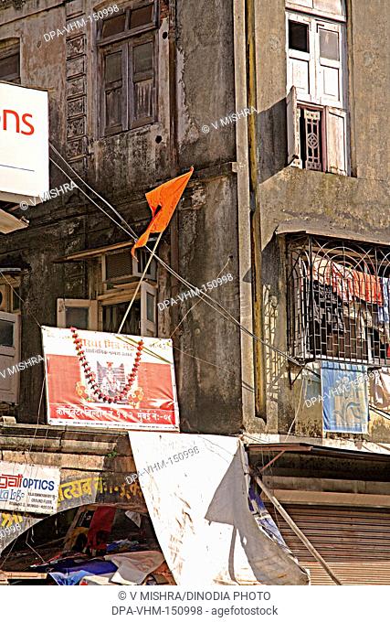 Old contractor building chawl mass urban housing and festival ganesh chaturthi hording ; Charni road ; Bombay Mumbai ; Maharashtra ; India