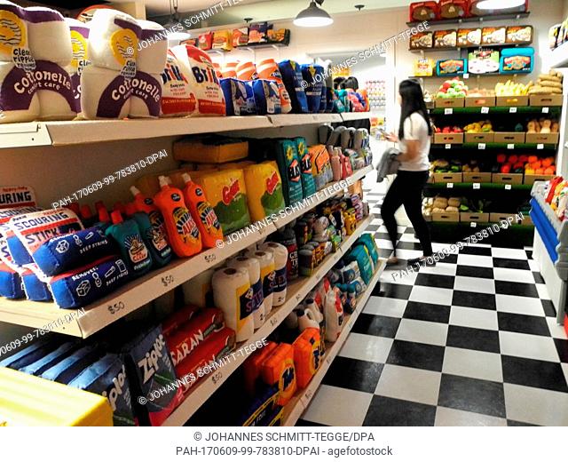 A woman walks through the grocery store '8 'till late' by the British artist Lucy Sparrow in which all products are made out of felt in New York, United States
